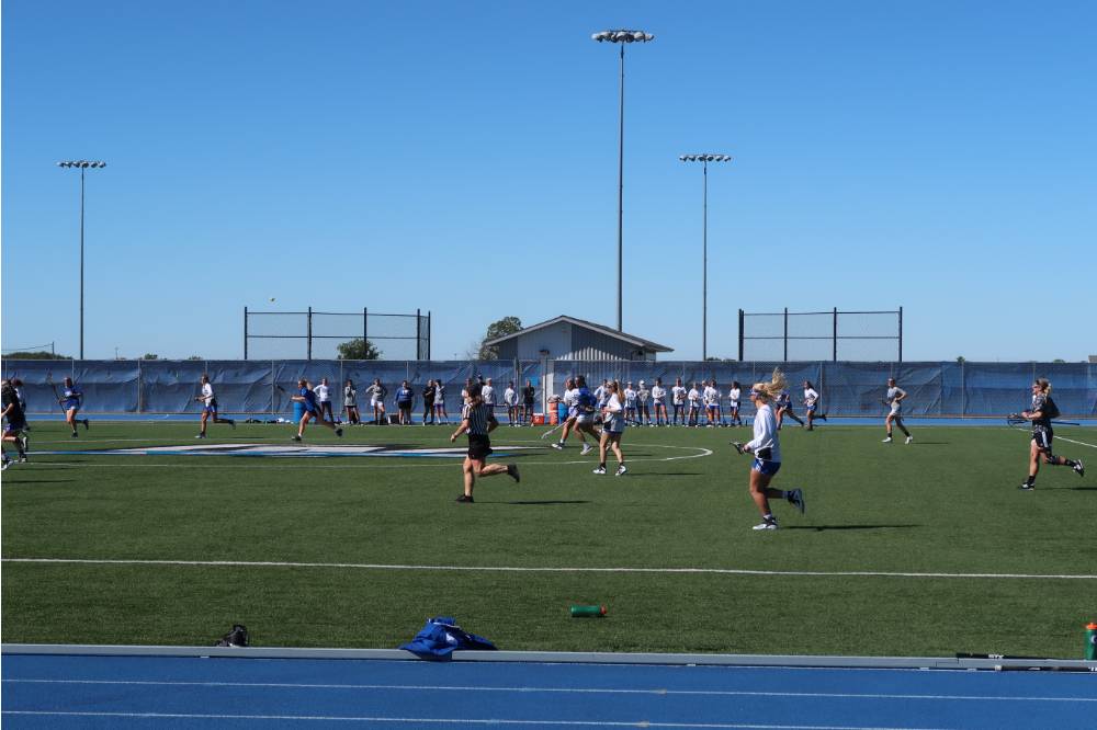 Lacrosse players playing on the field